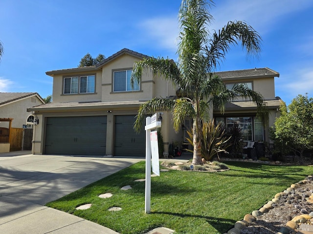 traditional home featuring stucco siding, an attached garage, concrete driveway, and a front yard