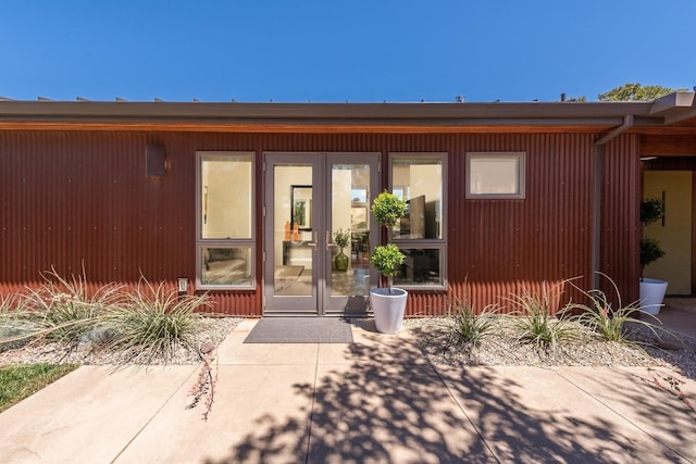 view of exterior entry with a patio