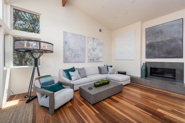 living room featuring visible vents, a healthy amount of sunlight, and wood finished floors