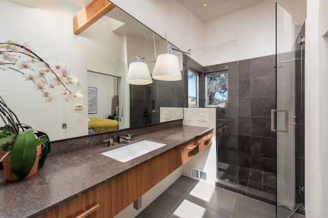 ensuite bathroom with vanity, visible vents, a stall shower, tile patterned flooring, and ensuite bathroom