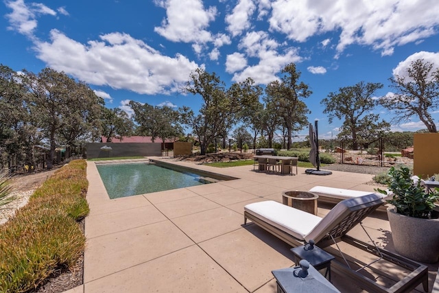 outdoor pool featuring outdoor dining space, a patio, and fence private yard