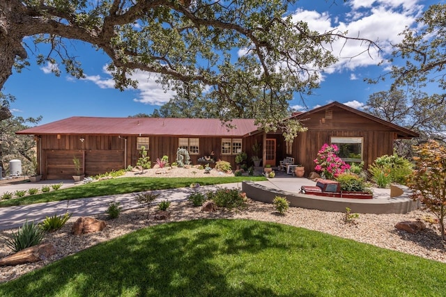 view of front of property with a yard, a garage, and board and batten siding