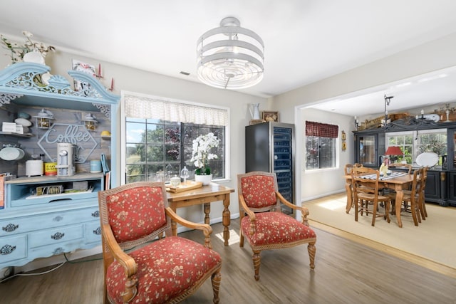 sitting room featuring a chandelier, wood finished floors, and visible vents