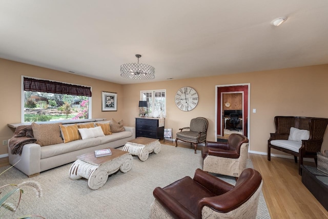 living area featuring baseboards and light wood-style flooring