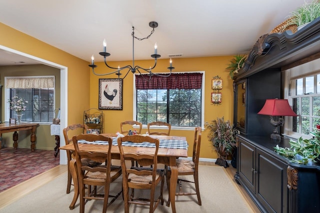 dining room with visible vents, a healthy amount of sunlight, and baseboards