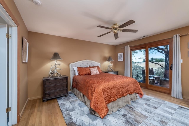 bedroom featuring access to outside, light wood-style floors, visible vents, and baseboards