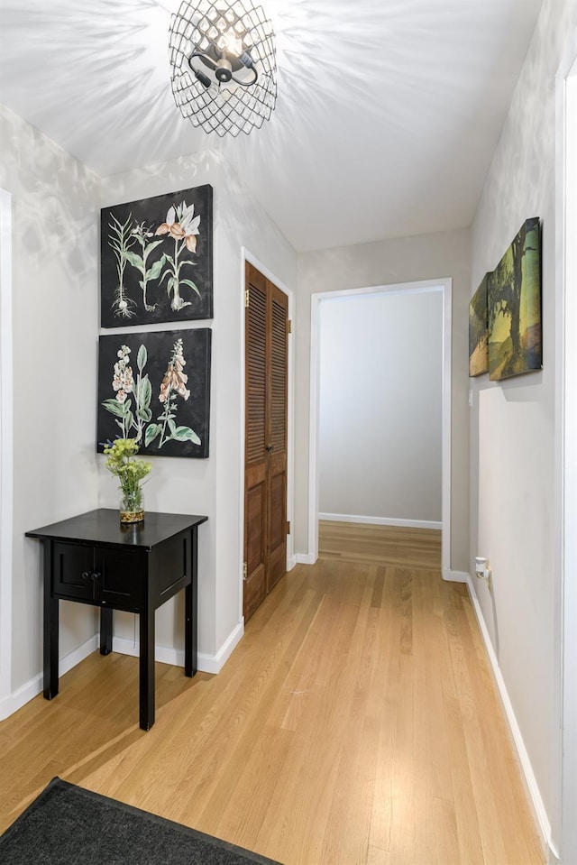 hallway with wood finished floors and baseboards