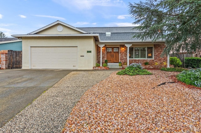 ranch-style home featuring a garage