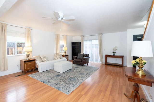 living room with ceiling fan and light wood-type flooring