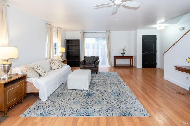 living room with ceiling fan and light hardwood / wood-style floors