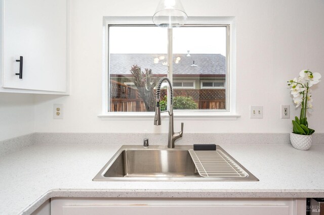 kitchen featuring white cabinetry and sink