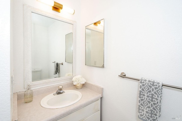 bathroom featuring vanity and toilet