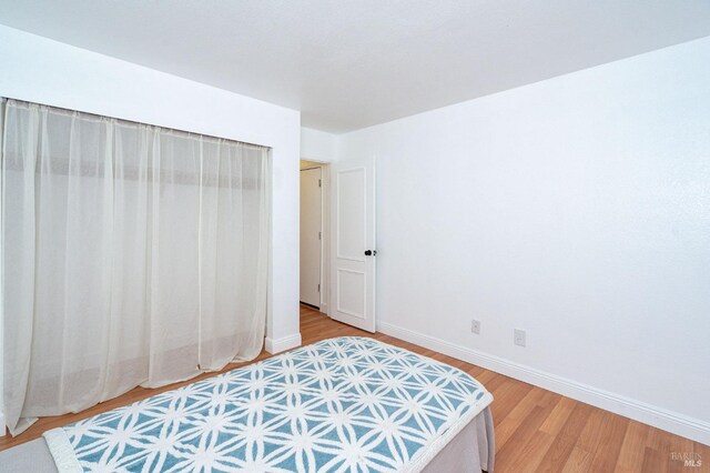 bedroom featuring hardwood / wood-style flooring and a closet