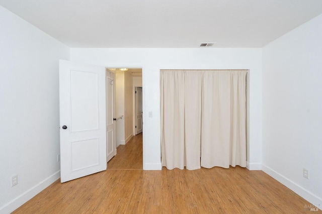 unfurnished bedroom with light wood-type flooring