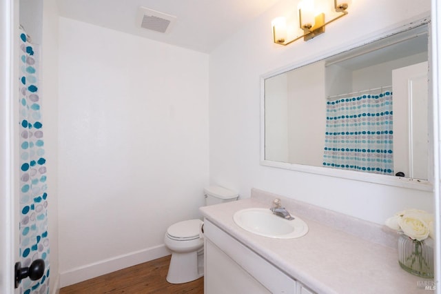 bathroom with a shower with curtain, vanity, toilet, and hardwood / wood-style floors