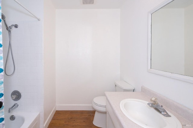 full bathroom with shower / tub combo with curtain, hardwood / wood-style floors, vanity, and toilet