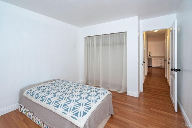 bedroom with hardwood / wood-style floors