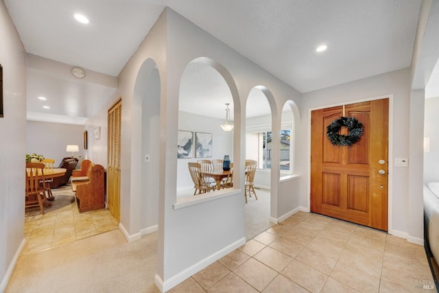 view of carpeted foyer entrance