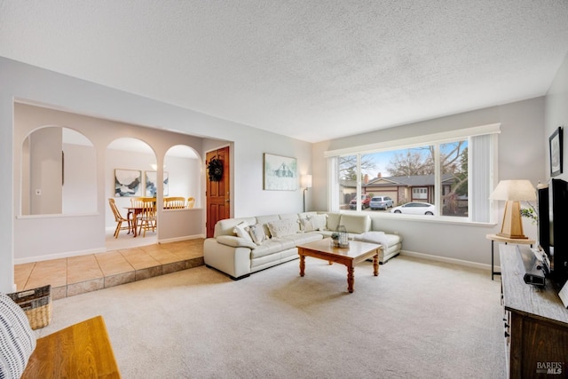 living room featuring light colored carpet and a textured ceiling