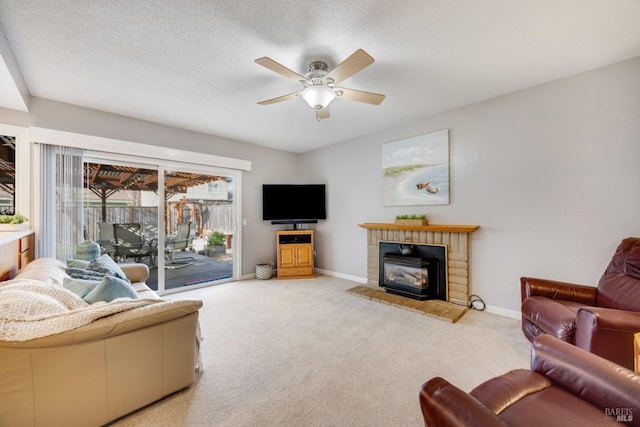 carpeted living room featuring a textured ceiling and ceiling fan