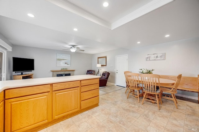 kitchen with ceiling fan and a fireplace