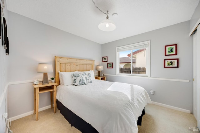 bedroom with light colored carpet and a closet