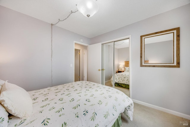 bedroom featuring a closet, a textured ceiling, and carpet