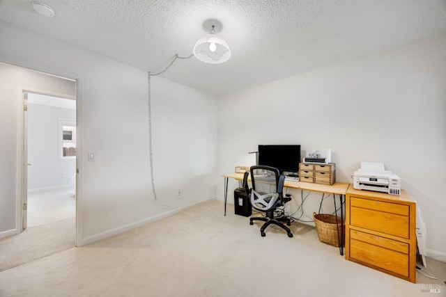 office space featuring light carpet and a textured ceiling