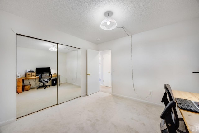 office area with light carpet and a textured ceiling