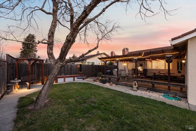 yard at dusk featuring a patio area