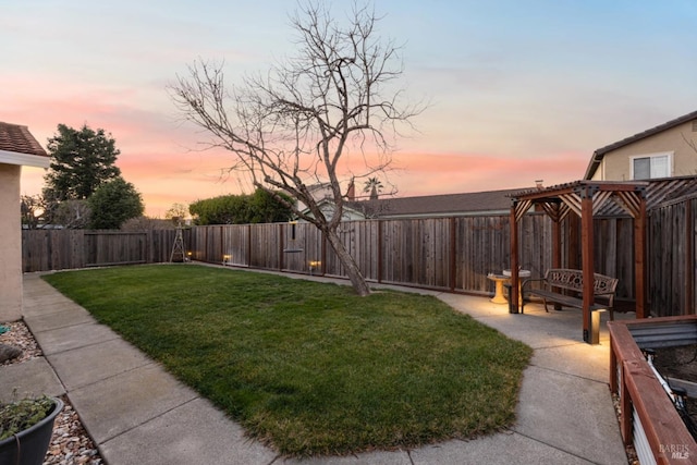 yard at dusk featuring a patio area and a pergola