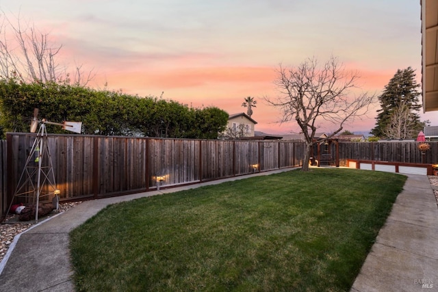 view of yard at dusk