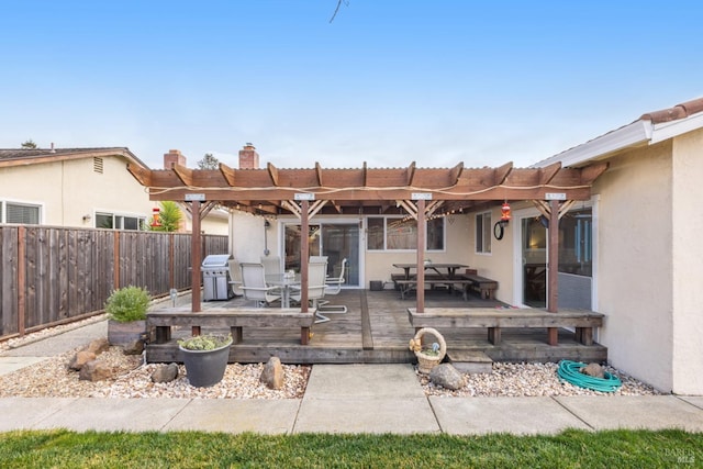 back of house featuring a deck and a pergola