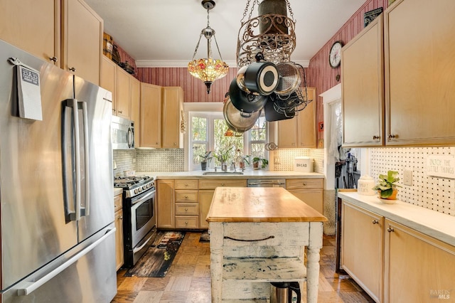 kitchen with appliances with stainless steel finishes, pendant lighting, sink, parquet floors, and light brown cabinets