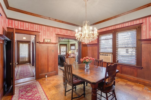 dining room with light parquet flooring, a chandelier, cooling unit, and crown molding