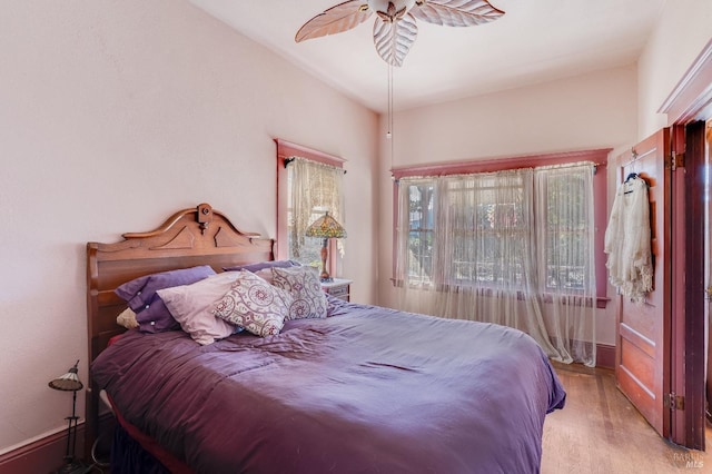 bedroom with ceiling fan and light wood-type flooring