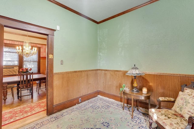 living area with a notable chandelier, crown molding, and wooden walls