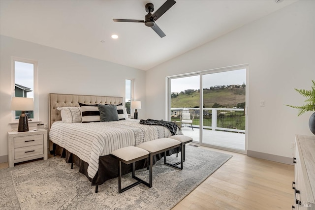 bedroom with ceiling fan, access to exterior, vaulted ceiling, and light hardwood / wood-style flooring