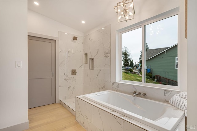 bathroom with hardwood / wood-style flooring, plus walk in shower, and vaulted ceiling