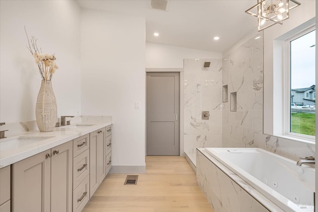 bathroom with vanity, shower with separate bathtub, and hardwood / wood-style floors