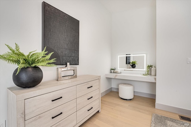 interior space featuring built in desk and light hardwood / wood-style flooring