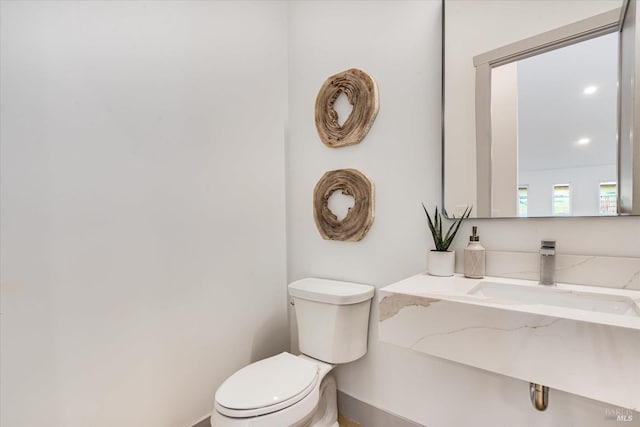 bathroom featuring toilet and sink