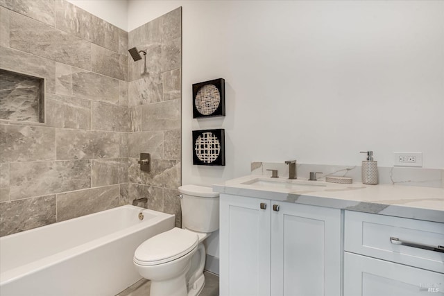 full bathroom featuring vanity, toilet, and tiled shower / bath