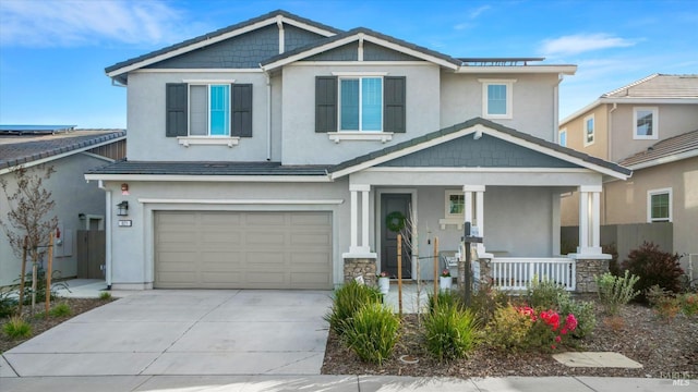 craftsman inspired home featuring a garage, driveway, a porch, and stucco siding