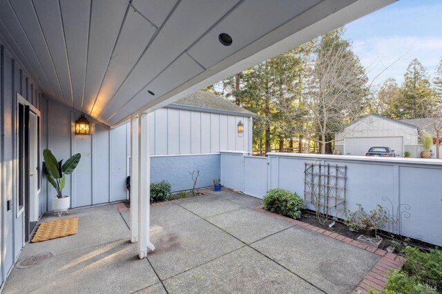 view of patio / terrace featuring a garage and an outdoor structure