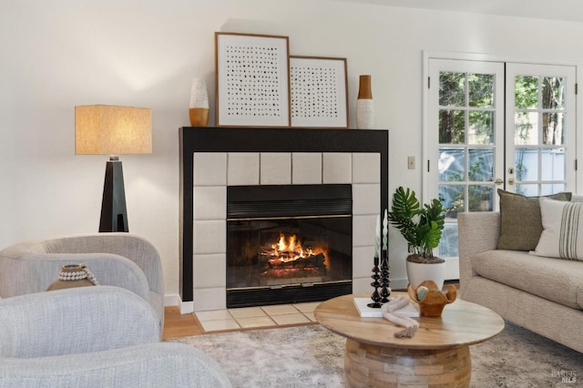 living area with a tiled fireplace