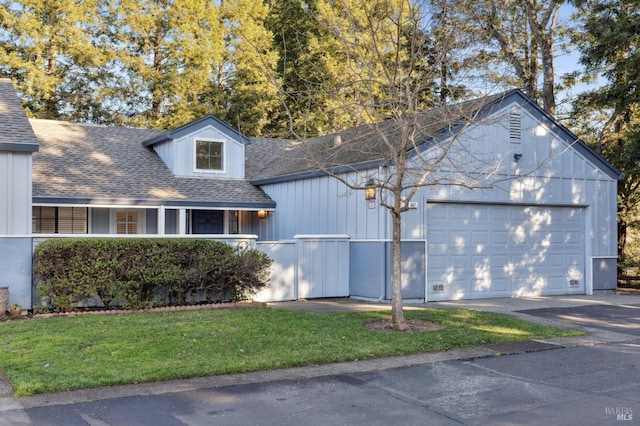 cape cod house featuring a garage and a front lawn