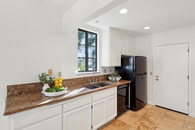 kitchen with sink, dark stone countertops, white cabinets, and black appliances