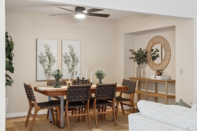 dining space with hardwood / wood-style floors and ceiling fan