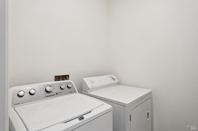 clothes washing area featuring washer and dryer